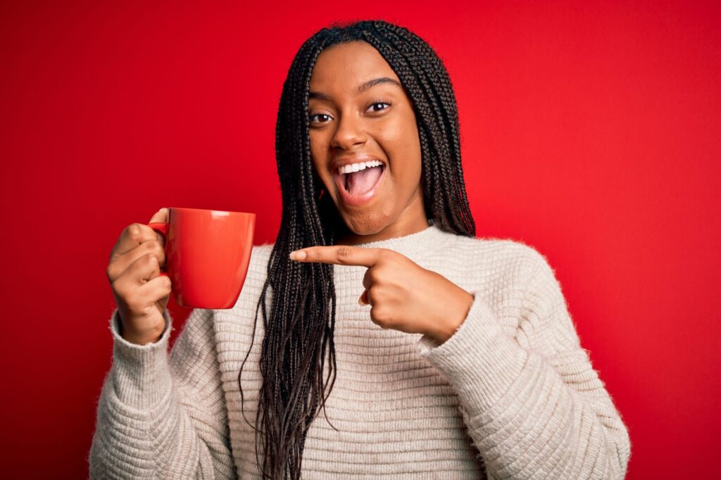 A woman holding a cup of coffee.