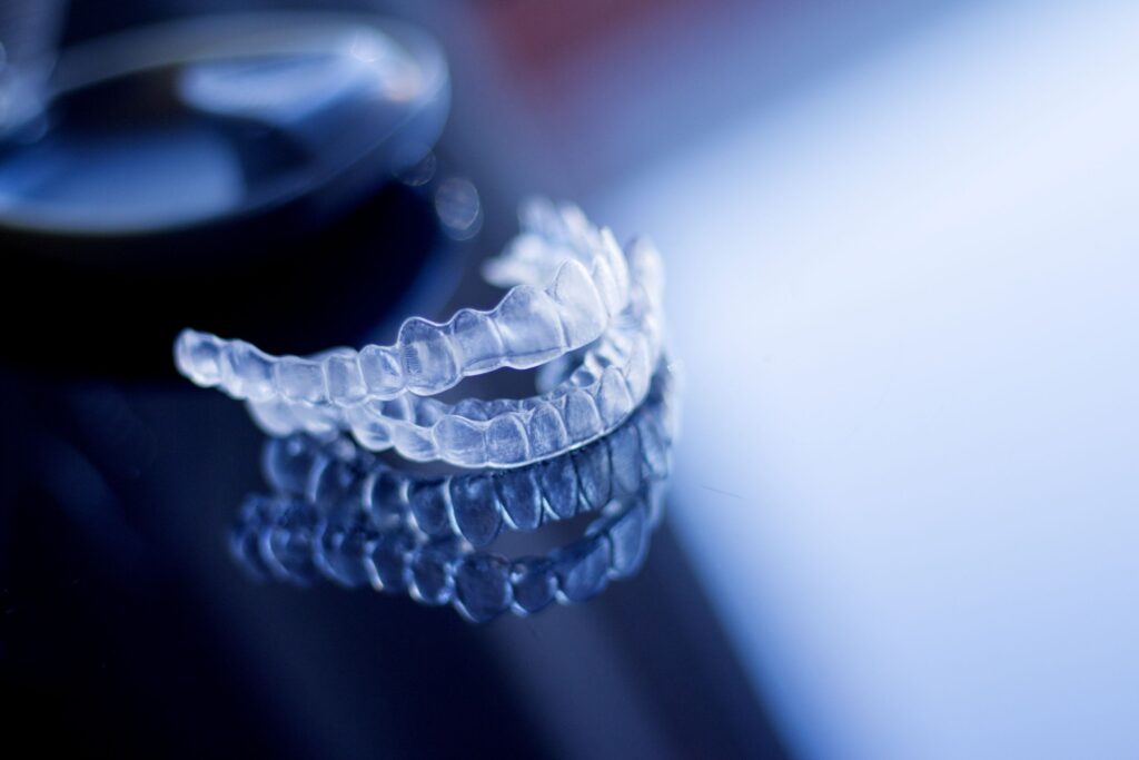 Clear aligners on a dark reflective surface